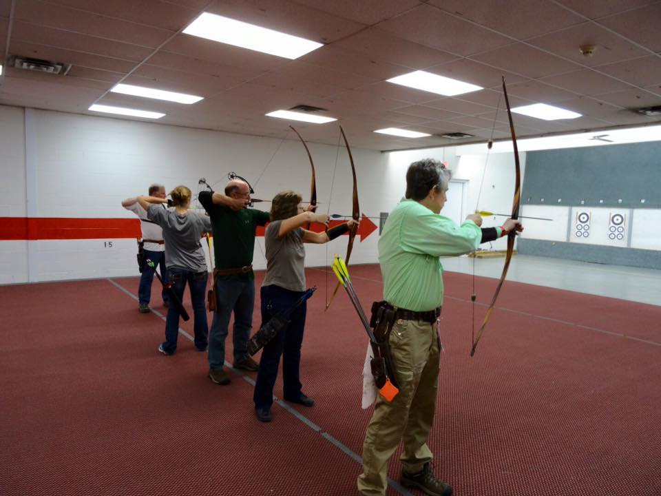 indoor archery range - people line up to shoot
