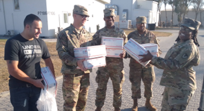 four soldiers hold the desert angel packages