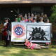 Participants and volunteers pose with the Ladies Adventure Day Banner.