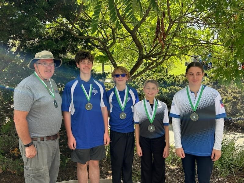 JOAD Archers and their coach show off their two gold and three silver metals